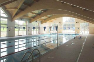 indoor swimming pool with lanes set up for swimmers